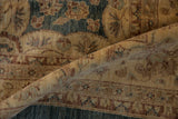 Dense pile of Peshawar carpet in dusty aqua, wheat, and copper with floral vine border.