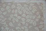 Hand-woven abrashed ground with dancing pale sand leaf pattern on a Soumac carpet.