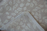 Hand-woven Indian Soumac carpet detail showing its back, intact side selvage, and ivory leaf pattern.