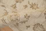 Hand-woven Soumac carpet texture, showing ivory and pale coffee brown Rococo florals.