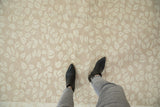 Subtle abrashed ground with tone-on-tone beige leaf pattern on the Indian Soumac carpet.