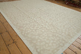 Side cord selvage and tone-on-tone leaf pattern on a contemporary Indian Soumac carpet.