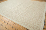 Hand woven Soumac rug with abrashed beige and ivory leaf pattern.