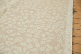 Tone-on-tone ivory leaf pattern on the subtle beige ground of a hand woven Soumac carpet.