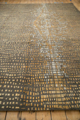 Manufacturer initials on top left of an Indian Abstract carpet with gold squares.