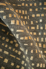 Rolled modern abstract carpet's pile with gold and ivory asymmetric squares.