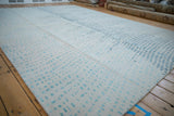 Indian Abstract carpet showing changing pattern of asymmetric squares and lines in ivory and blue.