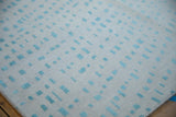 Hand-knotted Indian abstract carpet shows asymmetric powder blue shapes on an ivory pile.
