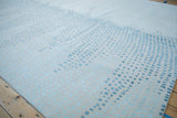 Abstract Indian carpet displaying asymmetric squares in ivory, powder blue, and pale turquoise.