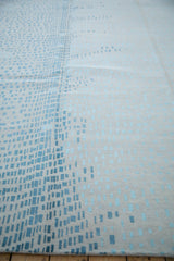 Abstract Indian carpet: shifting powder blue, dusty teal squares on ivory simulated silk pile.