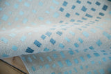 Simulated silk and wool pile with ivory and abstract blue squares.