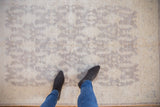Hand-knotted Peshawar rug with subtle ivory and oxidized silver geometric medallion lattice.