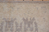 Peshawar rug's full pile texture with subtle ivory silver tone-on-tone geometric medallions and fringe.