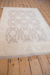 Tone-on-tone geometric shield medallion pattern on an ivory Peshawar rug.
