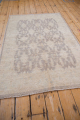 Peshawar rug's ivory, silver, oxidized silver tone-on-tone geometric shield medallions.