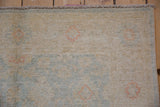 Peshawar rug's original full pile, intact selvage, and ivory with pale blue floral details.