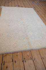 Peshawar rug's soft, even pile with subtle ivory, pale blue, and terra cotta florals.