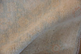 Peshawar rug's plush, full pile, displaying soft ivory, pale blue, and faint terra cotta hues.