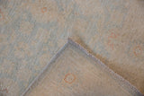 Dense pile of the Peshawar rug revealing pale blue floral motifs and its sturdy woven foundation.