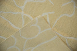 Pale saffron yellow contemporary Soumac carpet detail, ivory abstract lines, folded to show weave.