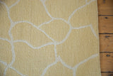 Hand woven Soumac carpet with pale saffron and ivory fluid organic outlines.