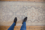 Peshawar runner's soft pile features floral and quatrefoil motifs in muted silver, ivory, pale blue.
