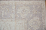 Peshawar carpet corner, delicate vinery and palmettes, oversized lotus border in ivory and beige.