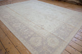 Peshawar carpet with delicate ivory palmettes and beige vinery on a full pile.