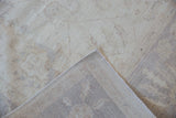 Hand-knotted Peshawar carpet with original side cord selvage and subtle ivory pile pattern.