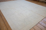 Intact side cord selvage of the hand knotted Peshawar carpet with plush ivory pile.