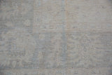 Full, even pile of a Peshawar carpet, revealing subtle floral motifs in ivory and silver.