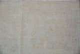 Peshawar carpet detail, highlighting the soft pile and subtle patterns in antique ivory and beige.
