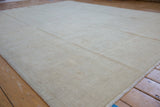 Pale beige Peshawar carpet with full even pile, revealing subtle floral motifs.