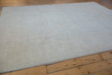 Peshawar carpet field, subtle palmettes and lotus flowers in pale seafoam and ivory.