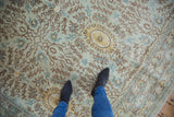 Peshawar carpet with pale seafoam, powder blue, and brown Aubusson-style cameo medallions, feet on full pile.