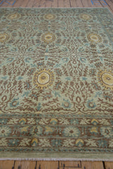 Detail of hand-knotted Peshawar carpet: seafoam green field, brown curvilinear border design.