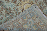 Peshawar carpet fold reveals seafoam, saffron Aubusson-inspired pile and woven back.