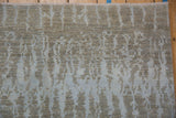 Textured detail of contemporary Pakistani rug pile, with soft silver and powder slate blue vertical patterns.