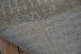 Contemporary Pakistani rug showcasing its soft, lustrous pile, original side cord, and woven back.