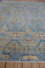 Contemporary Pakistani carpet detail with geometric pattern in silver, blue, saffron, and cochineal red.