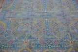 Close-up of the Pakistani Contemporary rug's geometric patterns in slate blue, yellow, and red.
