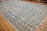 Intricate striated blue and ivory abrashes on a contemporary Pakistani carpet with finished side.