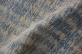 Textured pile close-up of contemporary Pakistani rug with striated ivory and blue abrashes.