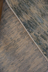Tightly woven hand-knotted foundation, corded edge, and striated blue and ivory pile.
