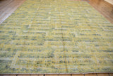 Textured contemporary rug showcasing geometric pattern in pale saffron yellow, silver, and ivory.