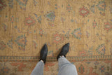 Vintage Indian Soumac rug section: dusty gold field, floral vinery, and arabesque border details.