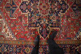 A close view of the rich, colorful geometric field on a vintage Persian Heriz carpet.