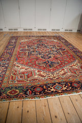 Vintage Heriz carpet seen from a low angle, highlighting its rich color and complex geometric patterns.