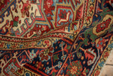 A folded close-up of a vintage Heriz carpet's dense pile and exquisite geometric patterns.