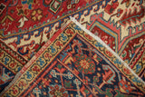 Folded corner of a collector Persian Heriz rug showing the hand-knotted back and original selvage.